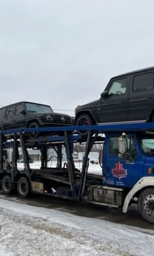 A.B. car transport between USA and Canada using red truck